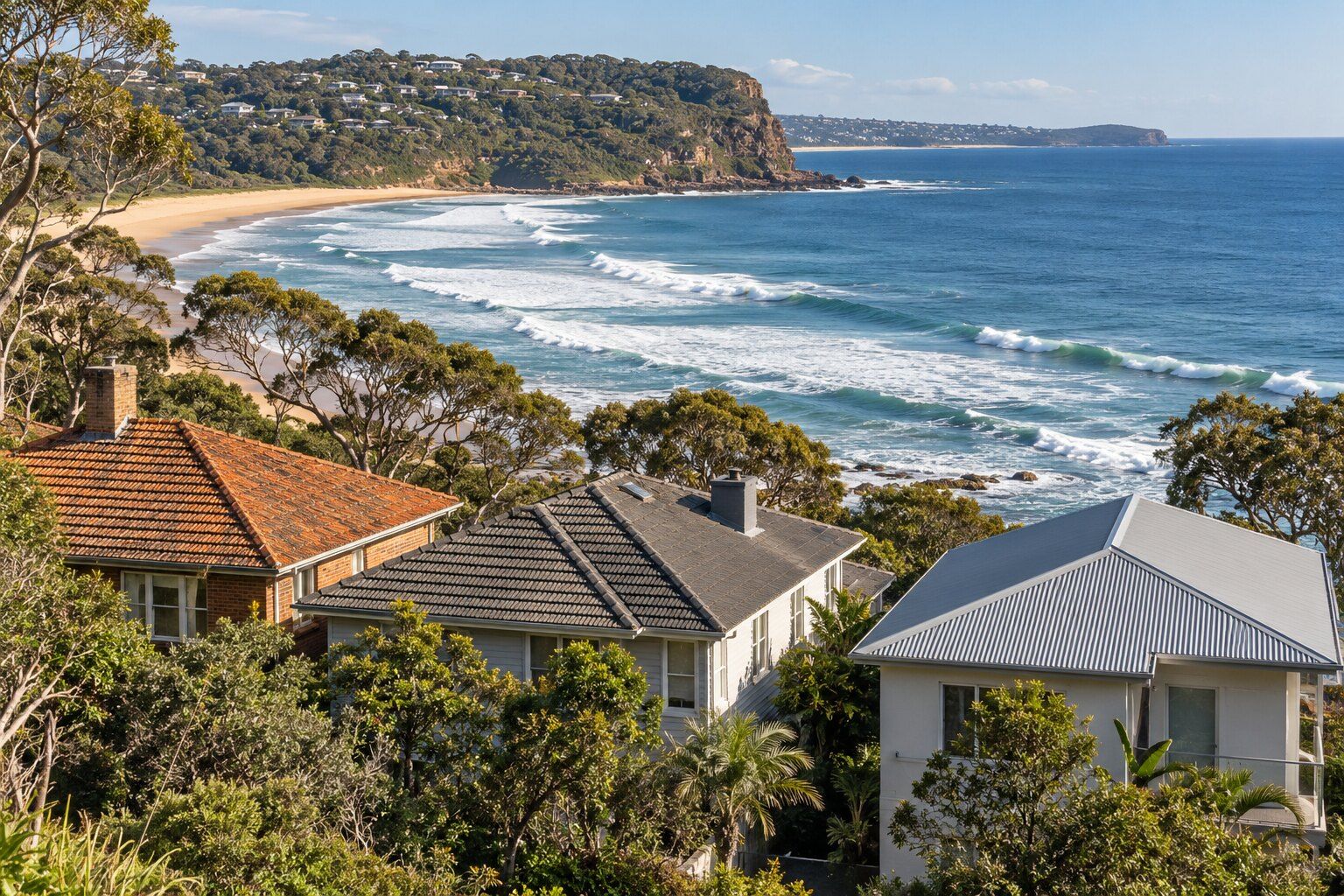 Terracotta, concrete and metal roofs, Northern Beaches: three neighbouring beach houses, one with each roof, above a surf beach